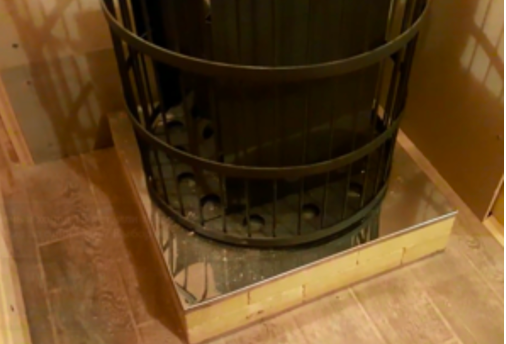 Stove in a bathhouse on a wooden floor 7